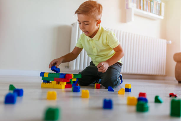 istock Small boy playing with toys on the floor 1050040532