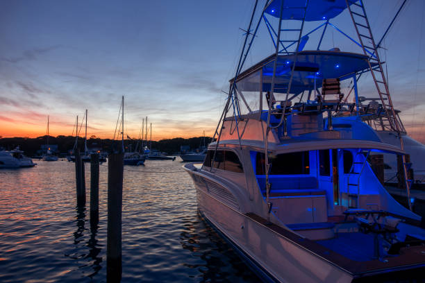 istock Multilevel motor boat with sunrise sunset sky dark reflections water blue vacation recreational parked at harbor 1050041028