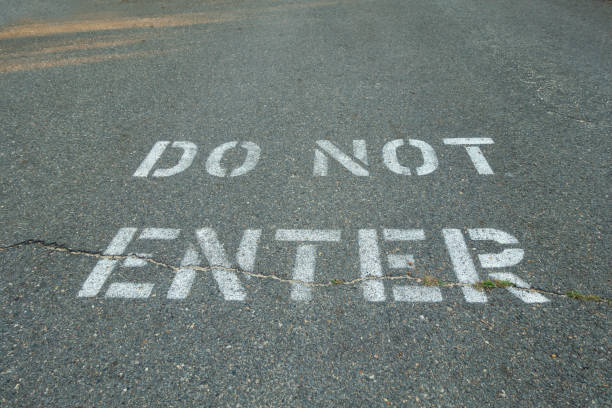 istock do not enter panted type on black tarmac street 1050041044