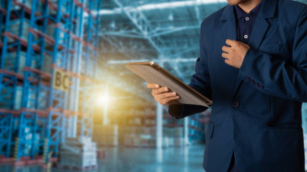 istock Businessman manager looking the tablet check and control for workers with Modern Trade warehouse logistics. Industry 4.0 concept 1050049922