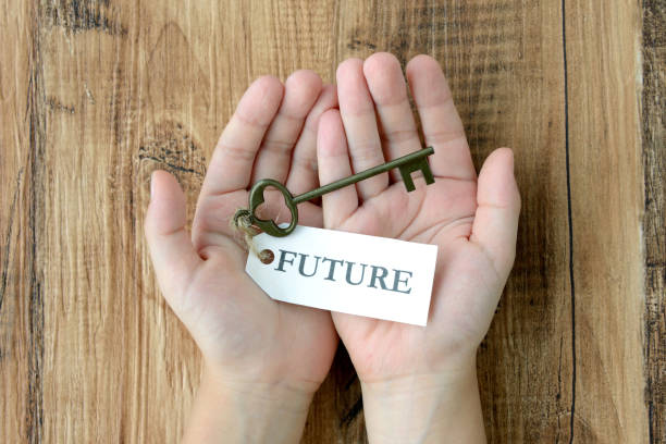 istock Child's hand and key with future tag 1050052330