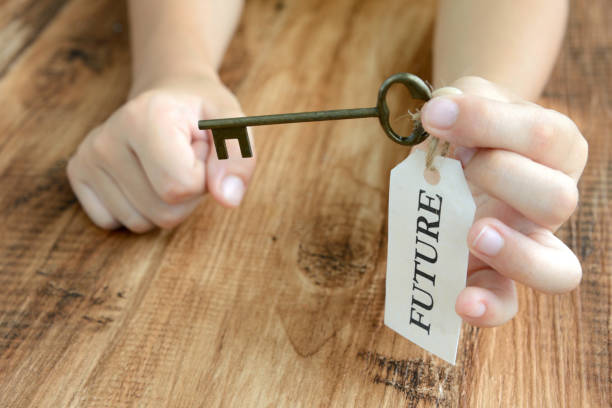 istock Child's hand and key with future tag 1050052438