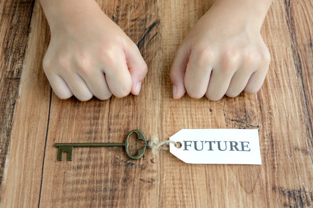 istock Child's hand and key with future tag 1050052466