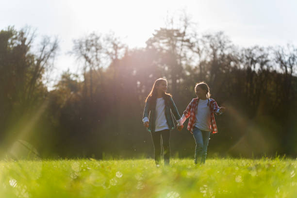 istock Two little girls walking in nature 1050052622