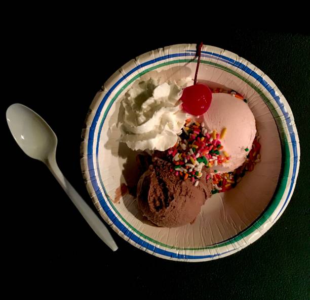 Ice Cream Sundae in a Paper Bowl and Plastic Spoon