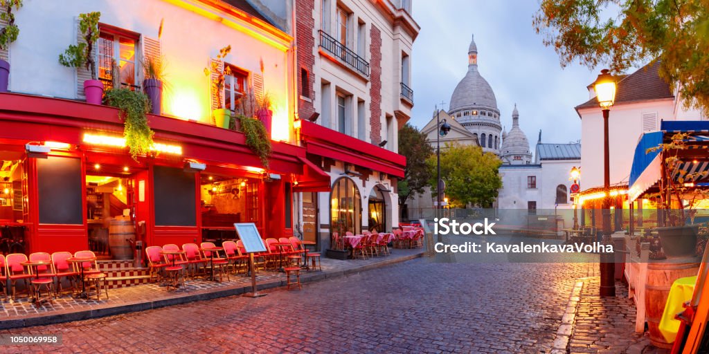 Montmartre in Paris, France The Place du Tertre with tables of cafe and the Sacre-Coeur in the morning, quarter Montmartre in Paris, France Paris - France Stock Photo