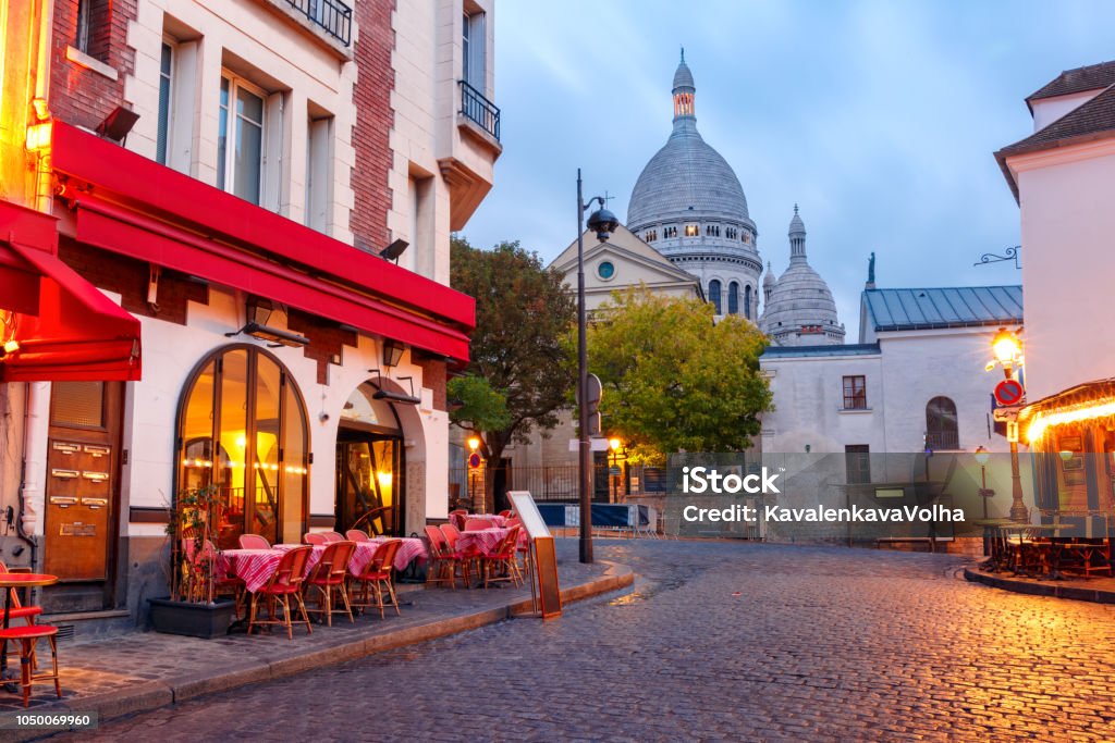 Montmartre in Paris, France The Place du Tertre with tables of cafe and the Sacre-Coeur in the morning, quarter Montmartre in Paris, France Paris - France Stock Photo