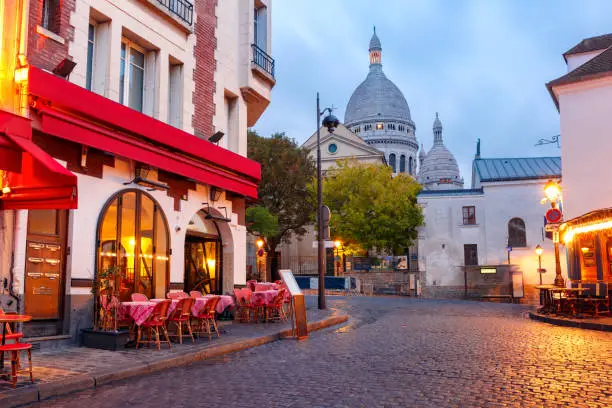 The Place du Tertre with tables of cafe and the Sacre-Coeur in the morning, quarter Montmartre in Paris, France