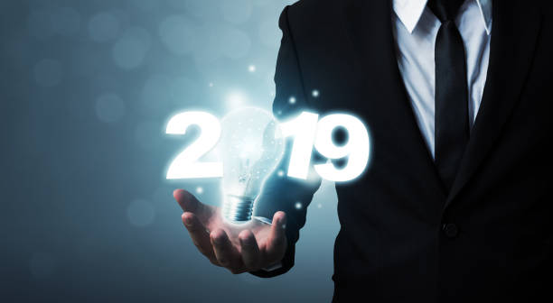 istock Businessman hand holding light bulb with year 2019 idea innovation technology concept 1050099508