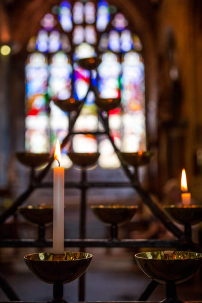 istock Prayer candles burning in a row inside church 1050109466
