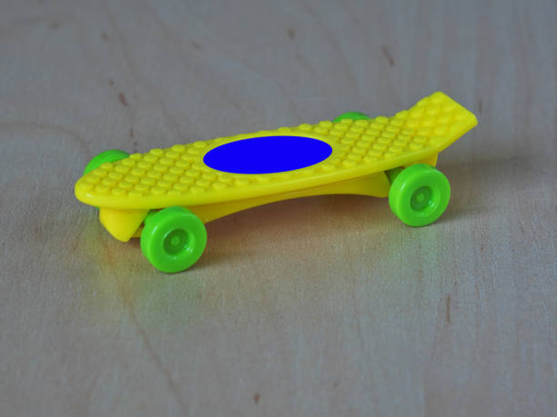 istock Yellow skateboard with green wheels 1050109626