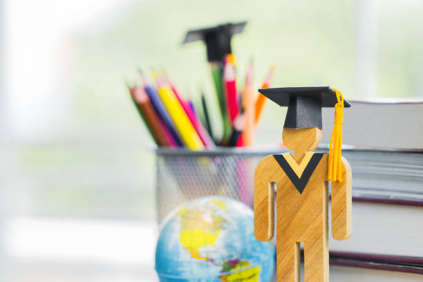 istock America Education knowledge learning study abroad international Ideas. People Sign wood with Graduation celebrating cap on stack textbook with model global map, alternative studying world wide 1050111770
