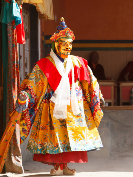 Unidentified monk performs a religious masked and costumed mystery dance of Tibetan Buddhism  at the traditional Cham Dance Festival. Lamayuru, India - June 16, 2012: unidentified monk performs a religious masked and costumed mystery dance of Tibetan Buddhism  at the traditional Cham Dance Festival. cham mask stock pictures, royalty-free photos & images