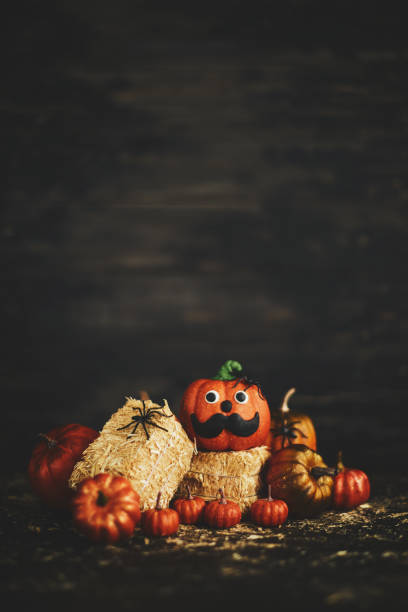 istock Rustic background with mustache face pumpkin on straw bales 1050119462