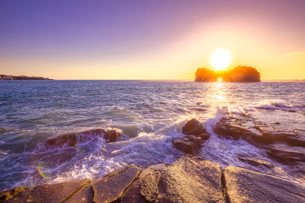 Rock in Sopelana beach with beautiful clouds on sunny day