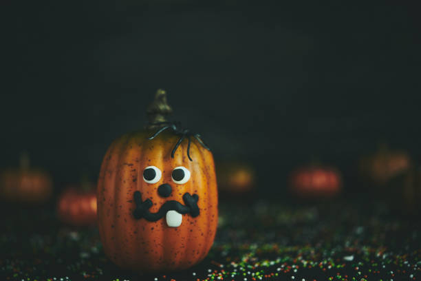 istock Pumpkin with tooth smile and spiders 1050121920