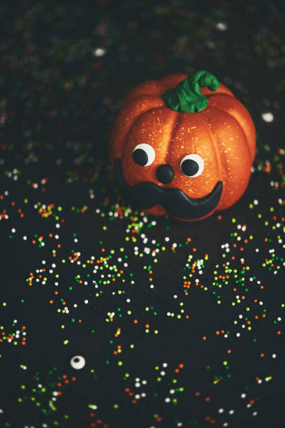 istock Pumpkin with mustache and colored sprinkles 1050121970