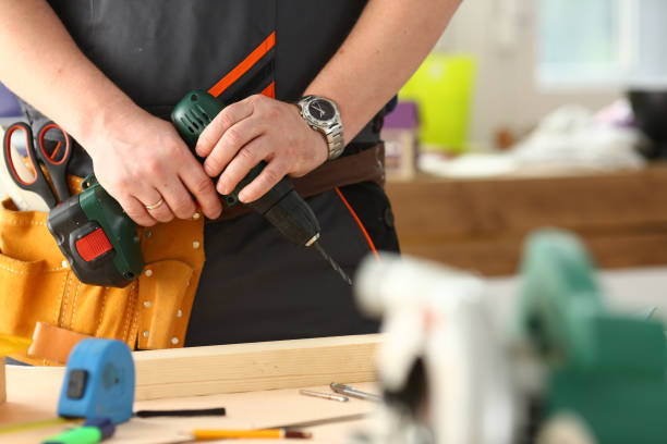 istock Arms of worker using electric drill closeup 1050124646