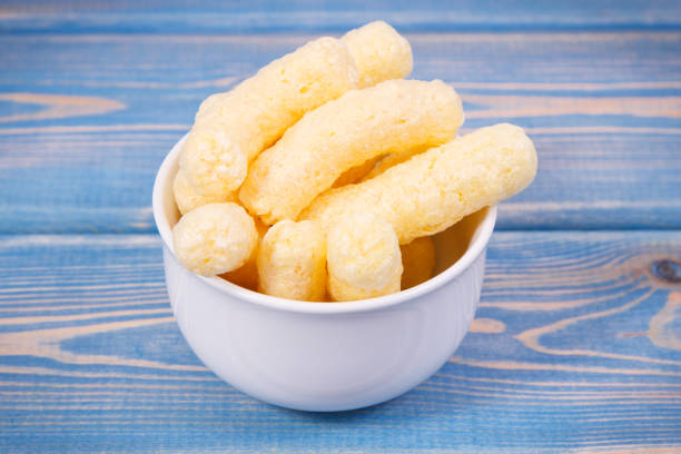 Cheese stick snacks, in a white bowl, isolated on white background
