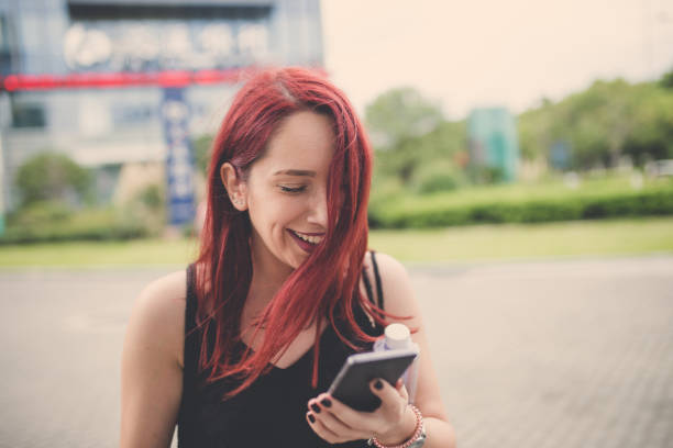 istock Cheerful Woman Texting Messages In City 1050143234