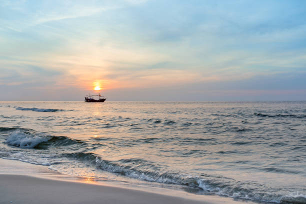 istock Beautiful summer sunset over Baltic sea. Sailing boat on horizon. 1050152030