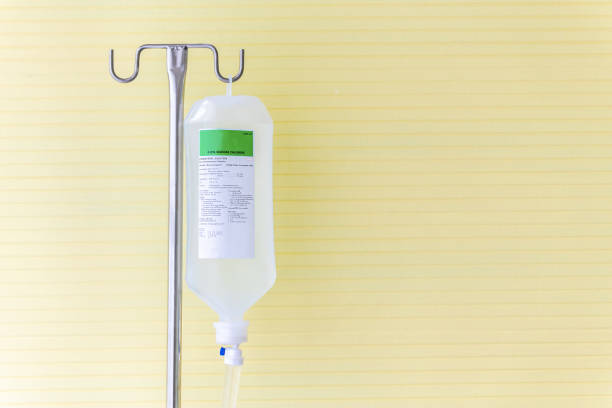 istock Saline solution fluid iv bag in emergency room at hospital. 1050154356