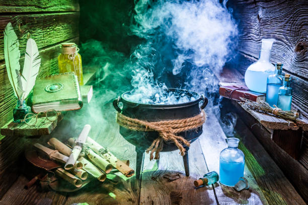 istock Halloween cauldron with blue and green smoke 1050157060