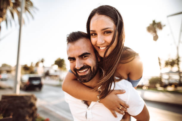 istock piggybacking couple at dusk on vacation 1050160166