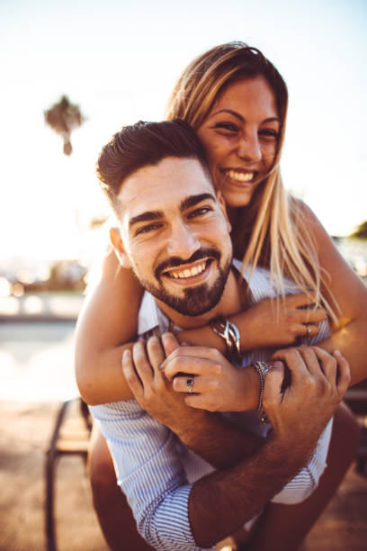 istock piggybacking couple at dusk on vacation 1050160284
