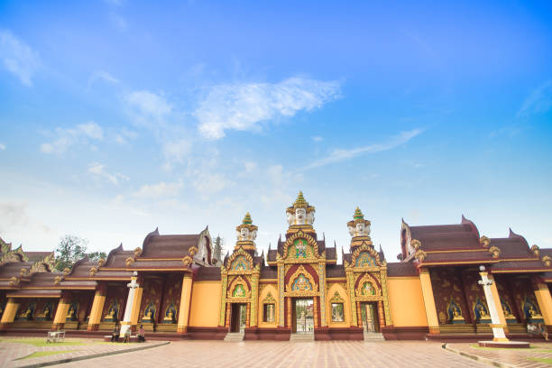 istock public temple 's wall gate with big giant head and buddha statue with cloudy blue sky backgrond in Krabi Province , southern of Thailand 1050166276