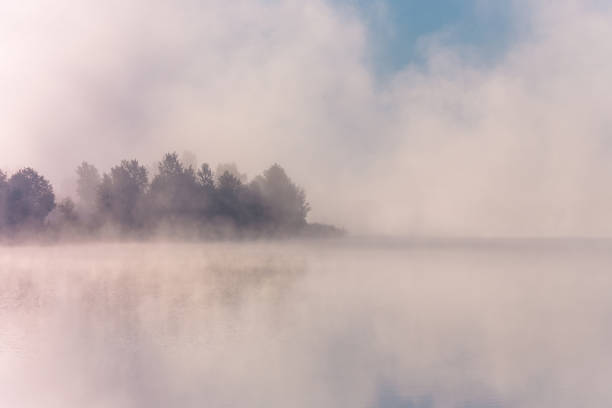 istock Sunrise over foggy lake. 1050174920