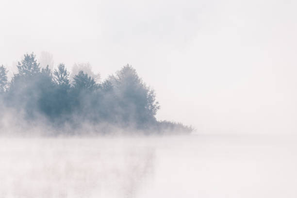 istock Sunrise over foggy river. 1050174980