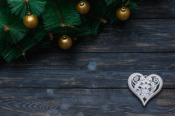 istock Christmas decorations under the tree on dark boards 1050180626
