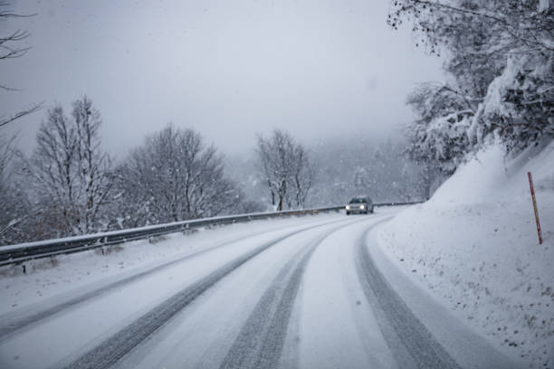 istock Car Driving on Slippery Road Covered With Snow 1050186736