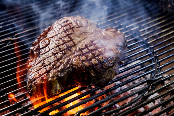 Porterhouse steak on the coals Porterhouse steak bake on the grill of the barbecue porterhouse steak stock pictures, royalty-free photos & images