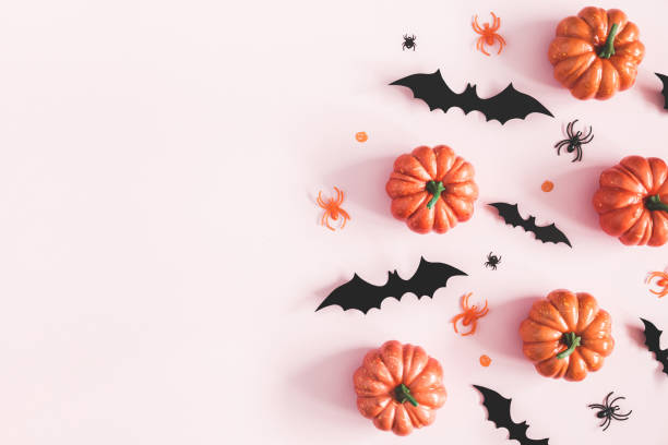 istock Halloween decorations on pastel pink background. Halloween concept. Flat lay, top view, copy space 1050189914