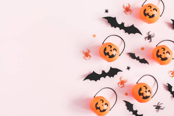 istock Halloween decorations on pastel pink background. Halloween concept. Flat lay, top view, copy space 1050189974