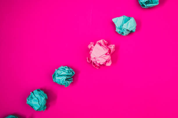 istock Design business concept Empty copy space modern abstract background Pink background with black and red letters, crumpled paper ball diagonally 1050206614