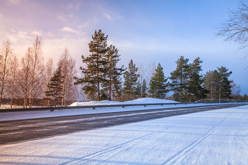 Empty rural asphalt road perspective, winter landscape, Finland