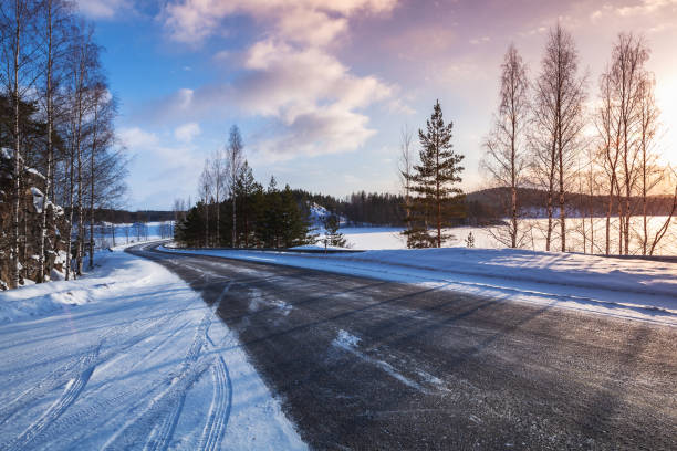 istock Empty rural road on a lake coast, winter 1050206760