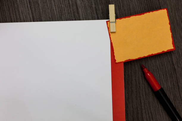 istock Design business concept Empty copy text for Web banners promotional material mock up template Open notebook page marker clothespin holding reminder wooden background 1050211804