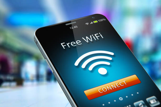Free WiFi network on smartphone in the shopping mall Creative abstract wireless networking on mobile devices business communication technology concept: color 3D render illustration of modern black glossy touchscreen smartphone with free WiFi connection message on screen in the shopping mall or airport terminal with selective focus bokeh blur effect free of charge stock pictures, royalty-free photos & images