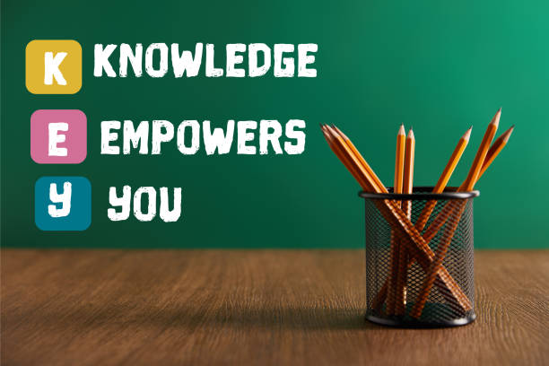 istock pencils on wooden table with green chalkboard on background with 