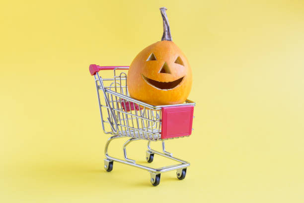 istock Jack o Lantern in small shopping cart on yellow background minimal creative concept. 1050222836