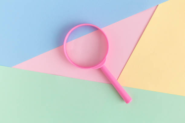 istock Magnifier on pastel background search minimalistic concept. 1050223024