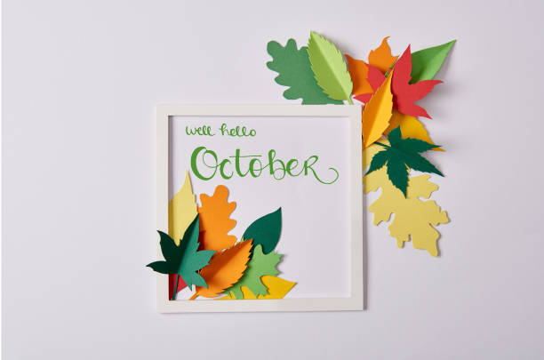 istock flat lay with handcrafted paper leaves and white frame with 