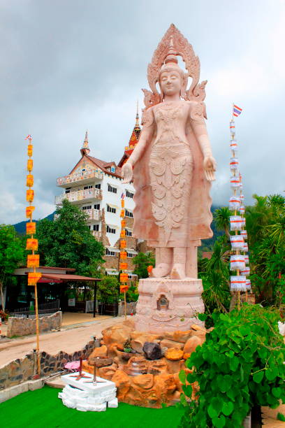 istock Huge statue of standing lord Buddha next to the five white sitting Buddhas at Wat Prathat, Pha Sorn Kaew, in Khao Kor, Phetchabun, Thailand. 1050232682