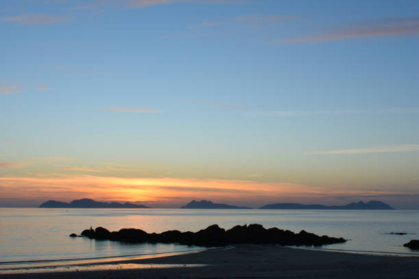 sunset at samil beach, Vigo View from the samil beach of the Cies Islands as the sun disappears on the horizon vigo stock pictures, royalty-free photos & images