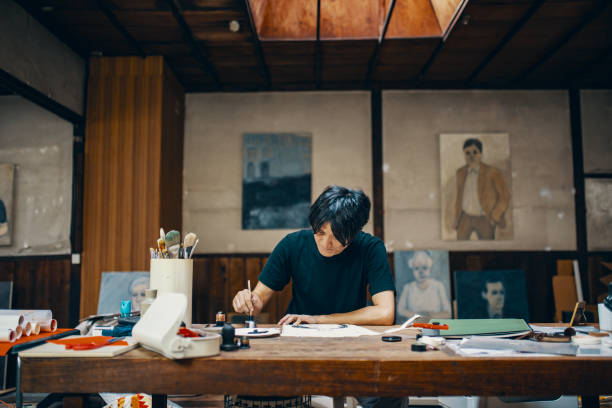 istock Mature male artist sketching ideas in his studio 1050236064