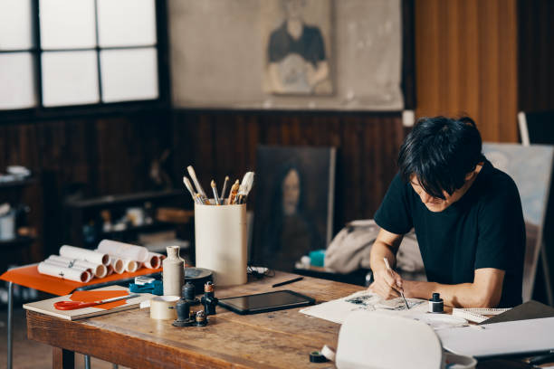 istock Mature male artist sketching ideas in his studio 1050236116